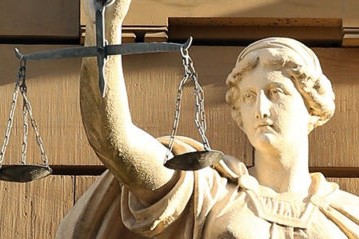 Ancient woman hold the scales of justice