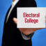 Hand hold a sign saying: Electoral College