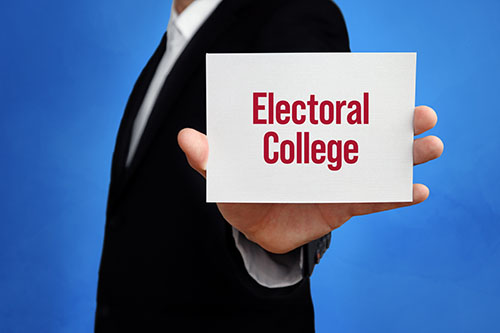 Hand hold a sign saying: Electoral College