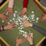 Hands sorting mahjong tiles on table top