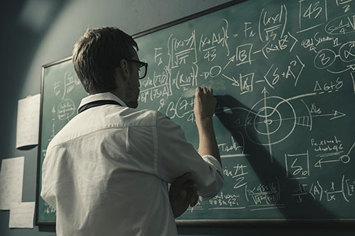 Teacher writing on the chalkboard