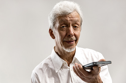 Senior man holding phone