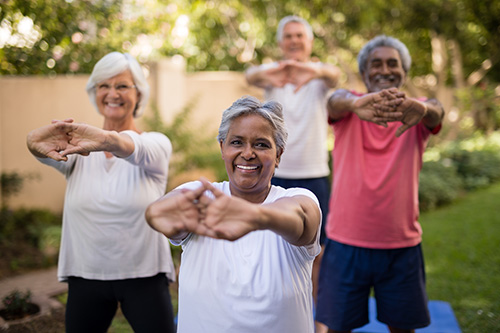 group of seniors doing stretching exercise