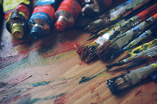 Tubes of oil paint and brushes