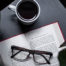 Open book with glasses and coffee
