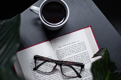 Open book with glasses and coffee