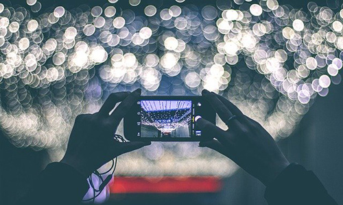 Person taking a digital photo with mobile phone