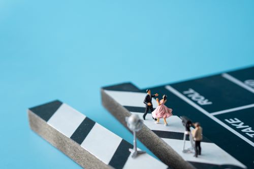 Figurines of dancers on a movie clapboard