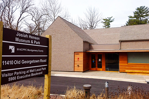Outside view of Josiah Henson Park visitor center and street sign
