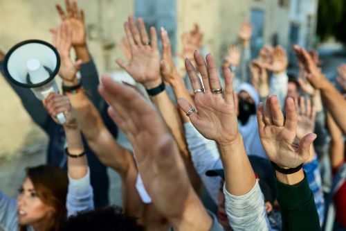 Hands raised in air at a protest