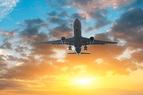 Plane taking off at sunset