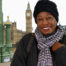 Smiling woman in front of tourist site in Europe