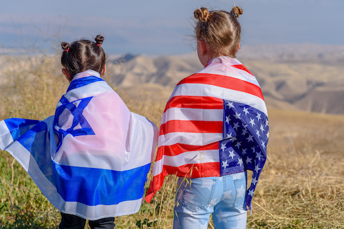 Two cute girls with American and Israeli flags.