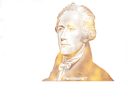 golden textured Alexander Hamilton cut on 10 dollar banknote isolated on white background