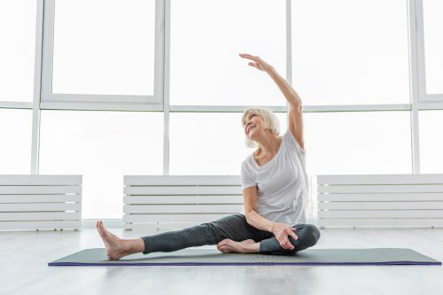 Woman sitting on mat in yoga pose