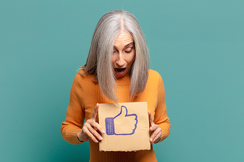 Woman holding thumbs up sign