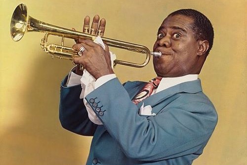 Photo of Louis Armstrong blowing his trumpet