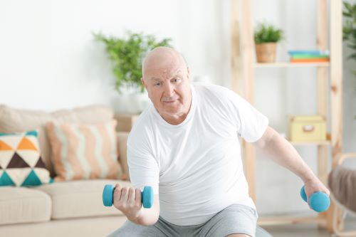 Seated man exercising with weights