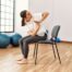 Woman sitting in chair doing a yoga pose