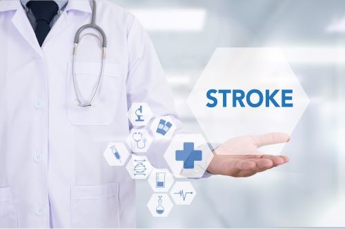 White coated medical professional standing behind the word "stroke"