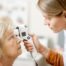 Photo of doctor examing a woman's eyes