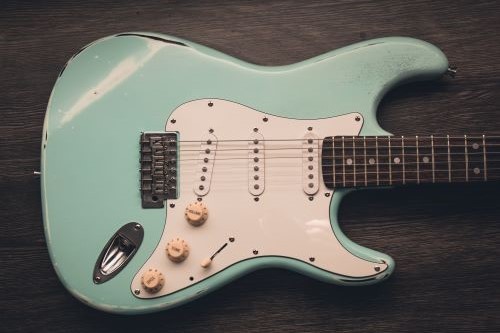 Close up of mint green and white vintage electric guitar