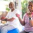Couple seated and lifting dumbbells