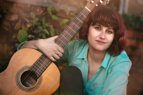 Photo of young woman with a guitar