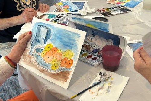 Person holding up a watercolor painting they made