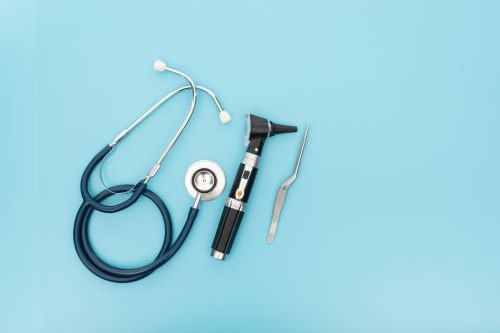 Photo of otoscope, stethoscope on a blue background
