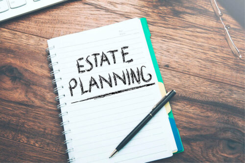 Notebook and pen, with the words Estate Planning written on a page
