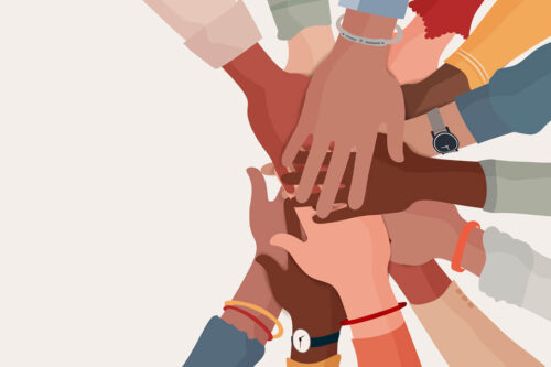 Multi-colored hands embracing each other