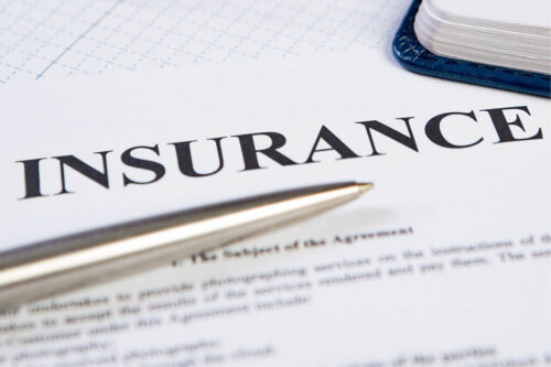 Page that says insurance with pen
