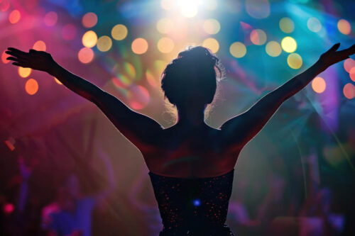Back view of a female singer in front of an audience