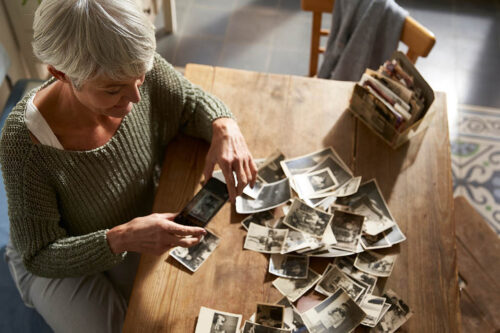 Image of a woman looking at a box of photos