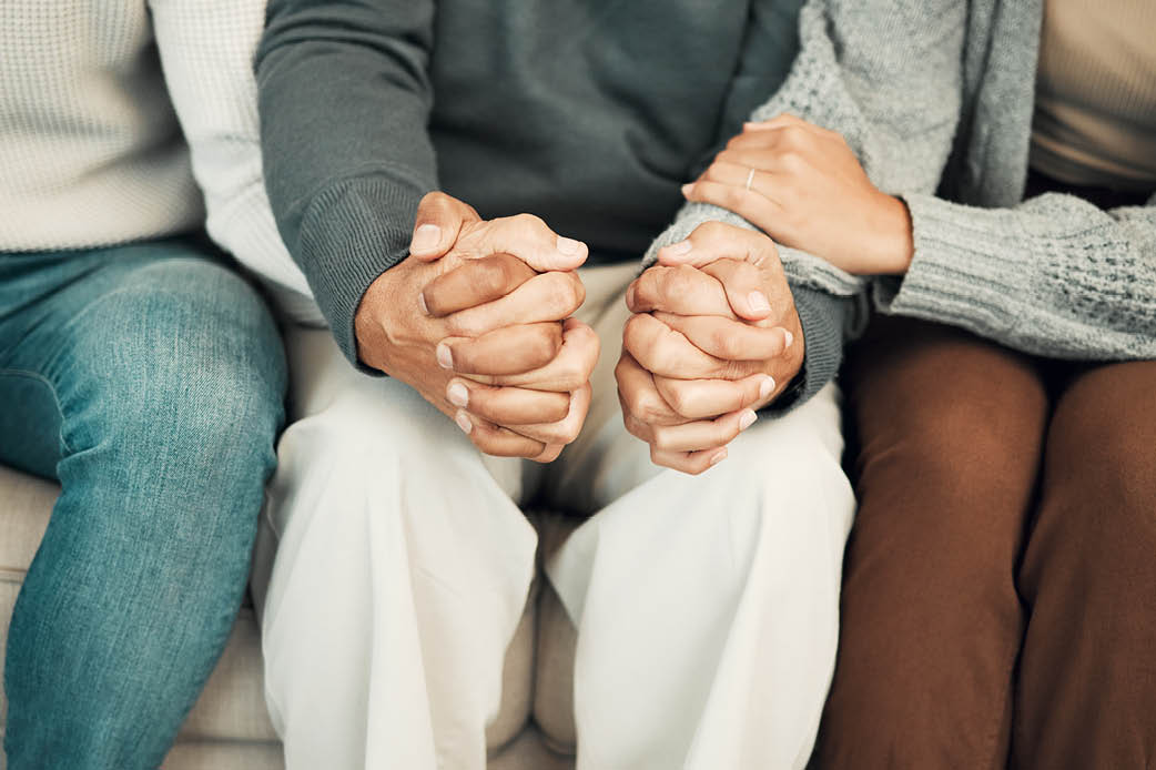 Adult Children Family Relationships Adult child sitting between and holding hands with their parents