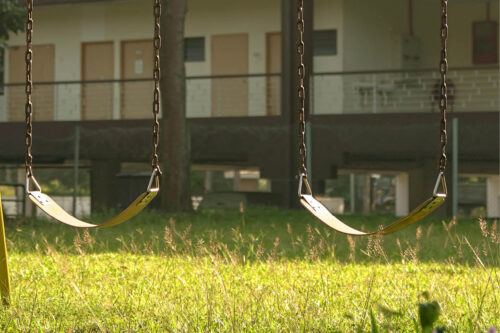 Two empty swings on a playground