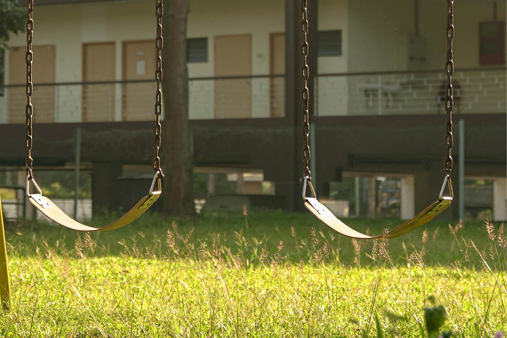 Missing children playground Two empty swings on a playground