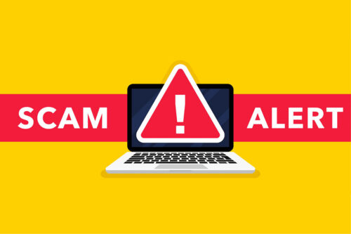 Cartoon of laptop with warning sign and the words scam alert