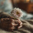 Close up photo of a hand holding flowers