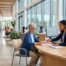 Woman helping an older adult woman in a government or office setting