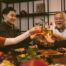 Photo of family around table toasting in celebration
