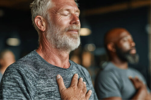 Man relaxing with hand on his chest and eyes closed