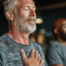 Man relaxing with hand on his chest and eyes closed