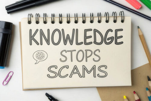 Notepad with words "Knowledge stops scams"