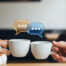 two people clinking their cups of coffee with speech bubbles above the cups