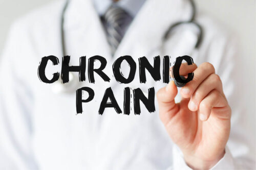 Doctor writing out "chronic pain" in big black text