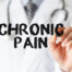Doctor writing out "chronic pain" in big black text