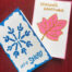 2 seasonal greeting cards, one with a snowflake and the other with a red leaf