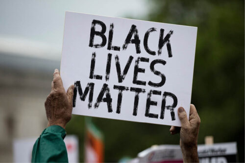 person holding up "Black Lives Matter" sign